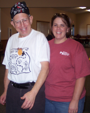 Woman and man standing next to each other, smiling